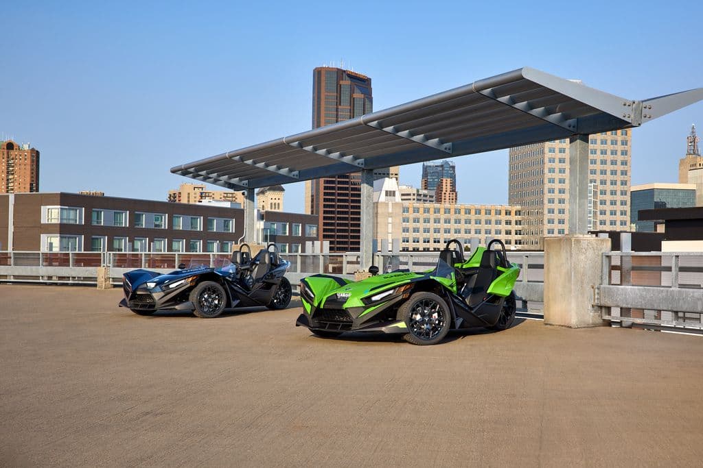 Two Polaris Slingshots parked side by side